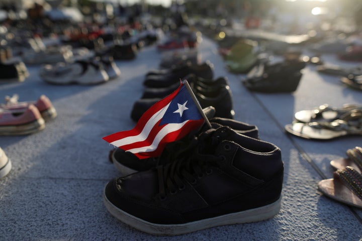 A Puerto Rican flag is seen on one of the hundreds of pairs of shoes displayed at the Capitol to pay tribute to Hurricane Maria's victims in San Juan, Puerto Rico, June 1, 2018.