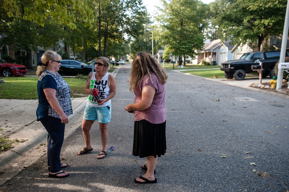 Pat Williams (left), Sally Leeman and Shannon Hicks gather in front of their homes to talk about the rising Cape Fear River,