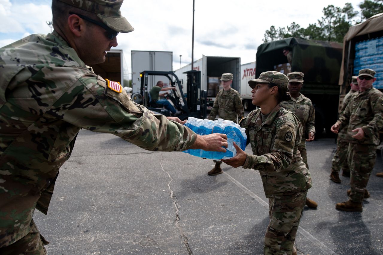 Members of the North Carolina National Guard load water onto a truck in Fayetteville, North Carolina, on Monday.