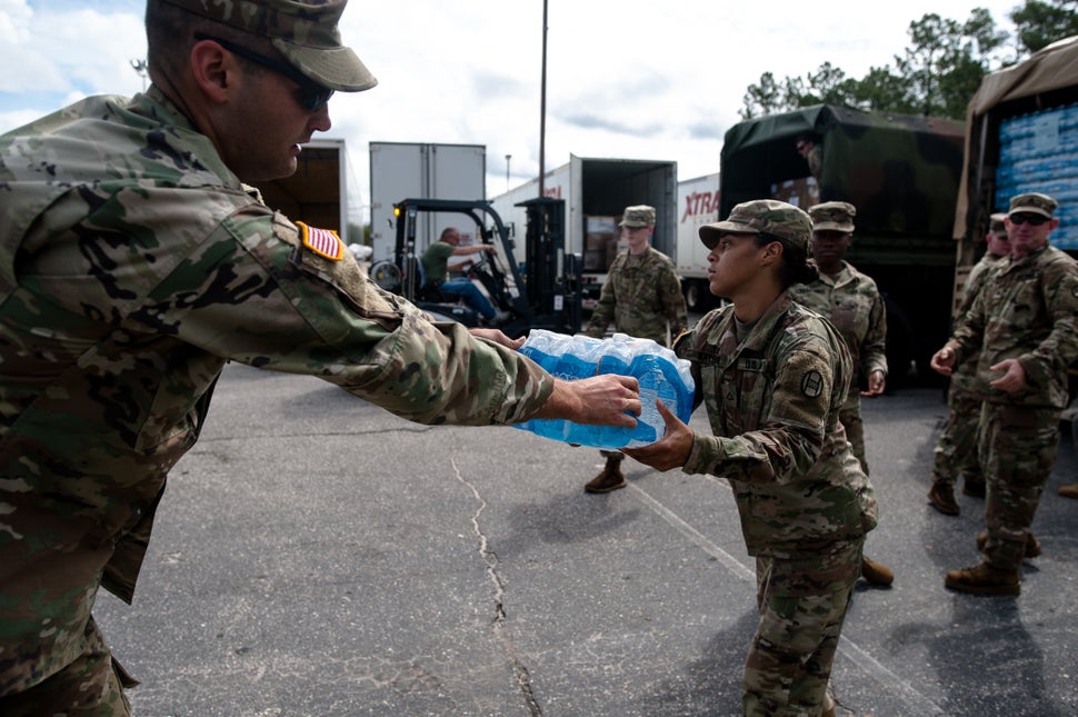 Members of the North Carolina Guard load water on a truck in Fayetteville, North Carolina on Monday.