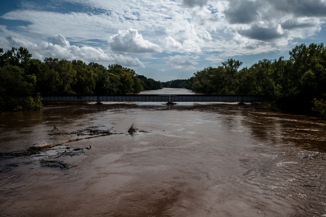 Trees and other debris flow down the flooded Cape Fear River in Fayetteville, North Carolina, on Monday
