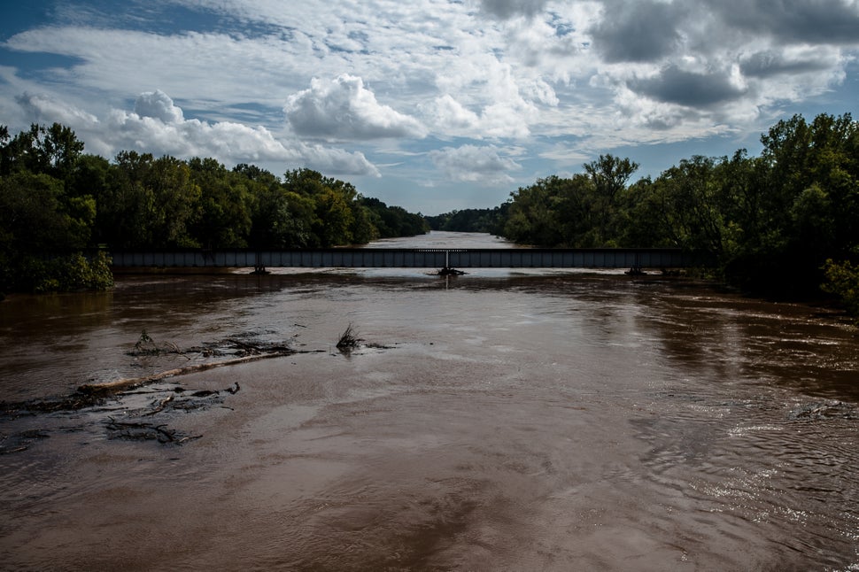 Trees and other debris flow into the Cape Fear River in Fayetteville, North Carolina on Monday.