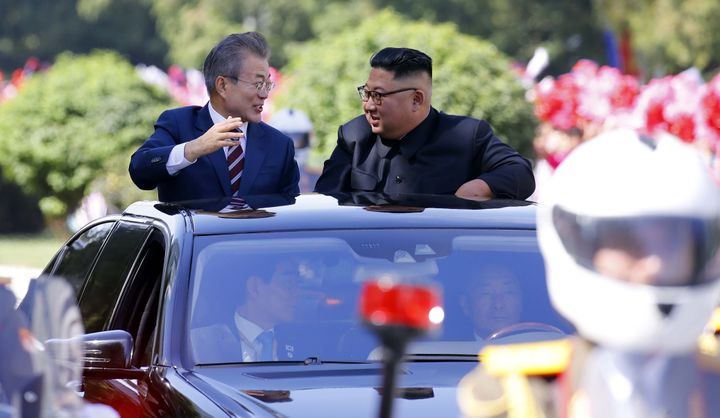 South Korean President Moon Jae-in, left, and North Korean leader Kim Jong-un ride in a car parade in Pyongyang on Tuesday.
