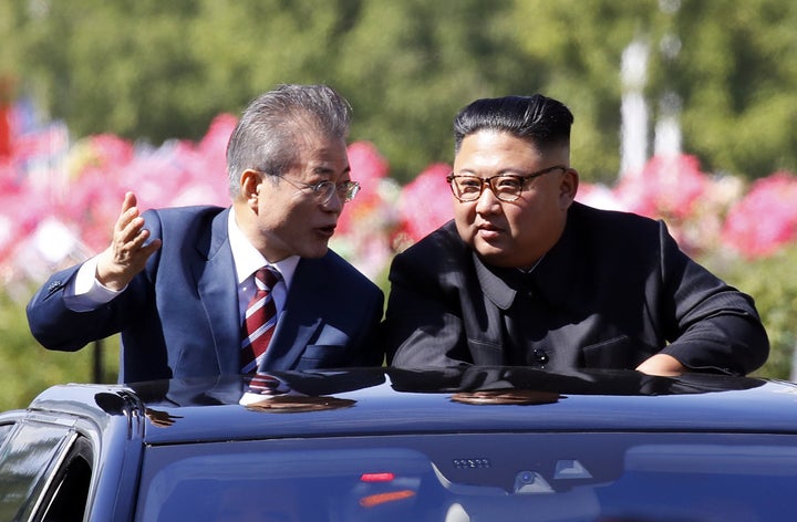 South Korean President Moon Jae-in (L) and North Korean leader Kim Jong Un ride in a car parade on Sept. 18, 2018, in Pyongyang.