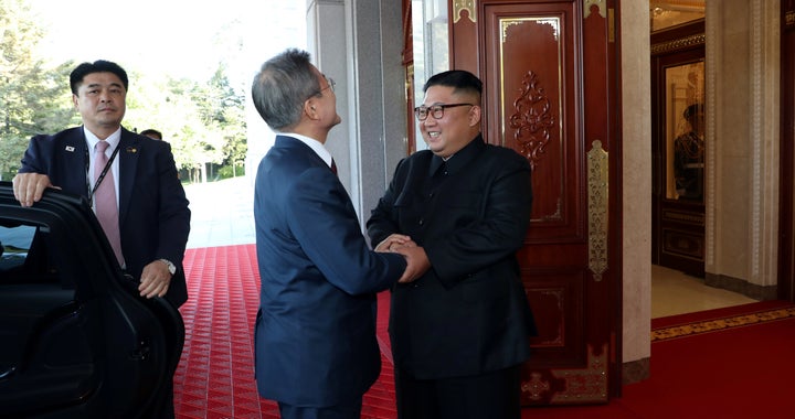 South Korean President Moon Jae-in is greeted by North Korean leader Kim Jong Un as he arrives at the headquarters of the Central Committee of the Workers' Party of Korea for their meeting.