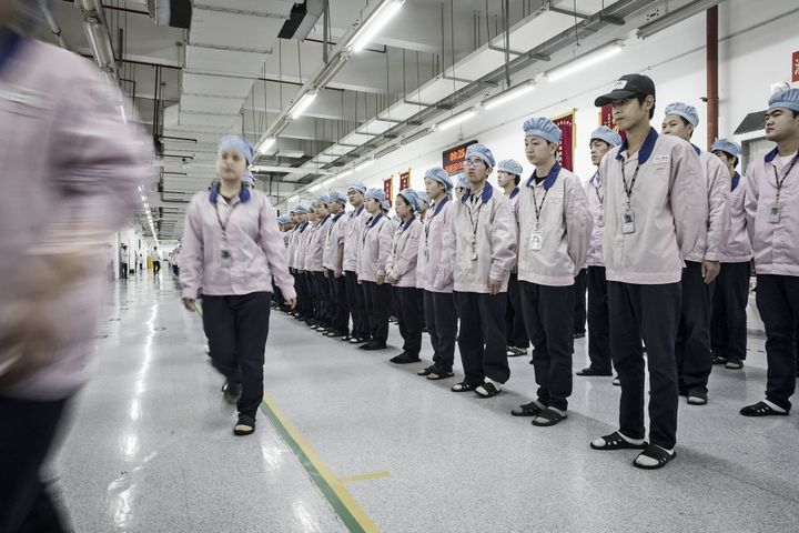 Workers in a Shanghai factory where Apple products are made.