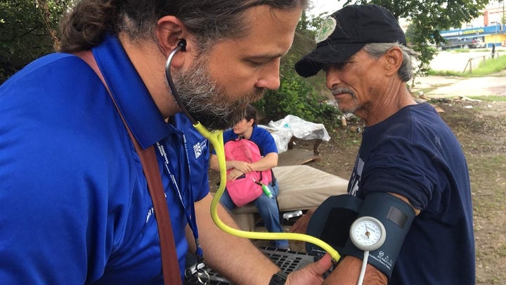 Physician assistant Joel Hunt treats Raul Reyes, 59, at a homeless encampment outside of downtown Fort Worth, Texas. 