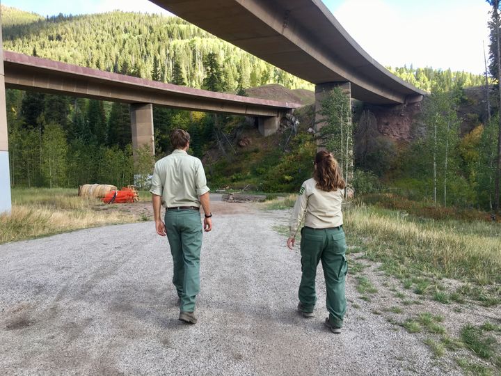 Michael Beach, wilderness and trails manager for the U.S. Forest Service Eagle-Holy Cross Ranger District, and Marcia Gilles, deputy district ranger, walk toward a meadow on the outskirts of Vail that’s been a hotspot for illegal camping in the past. Towns and counties in the area are helping fund additional Forest Service seasonal workers to help monitor problems such as illegal camping and campfires, trash and overcrowded trails. 