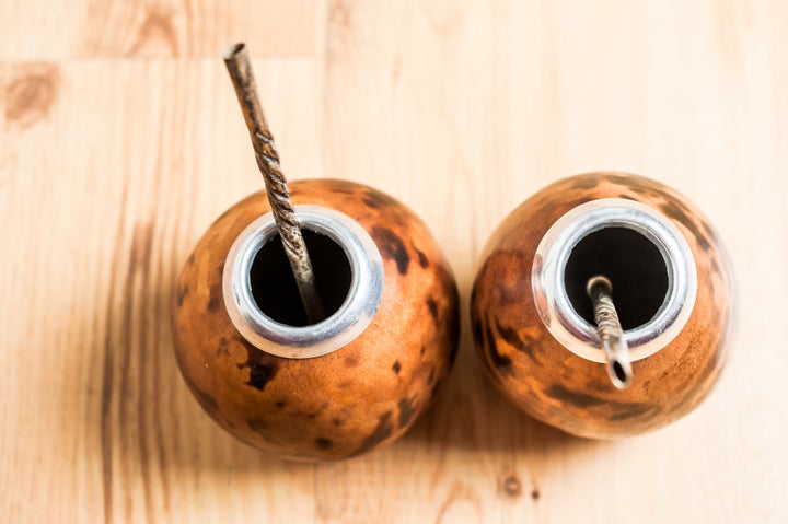 Traditional vessels used to drink yerba mate included metal or wooden straws.