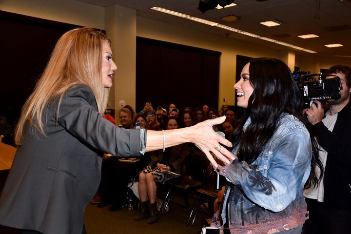 Demi Lovato (R) surprises her mother, author Dianna De La Garza, at her book signing of 'Falling with Wings."