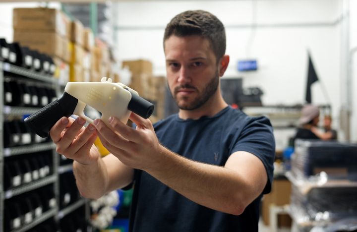 Cody Wilson poses with a 3D-printed gun in his factory in Austin, Texas, on Aug. 1, 2018. Austin authorities charged Wilson with sexually assaulting a child on Wednesday.