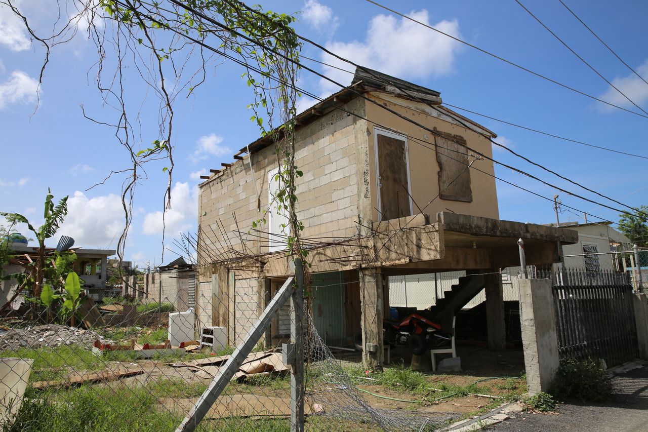 Before the hurricane, Keishla Acevedo lived in her grandmother's home with her husband and son. The house, pictured here shortly after Maria, lost part of its roof and suffered other structural damage during the storm.