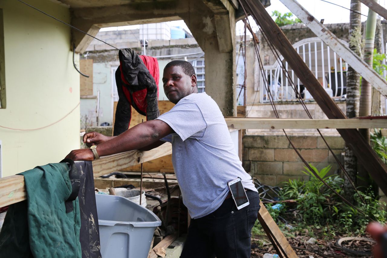 After sorting through his damaged belongings, Juan Medina-Dishmey rests on his front porch three weeks after the storm. 