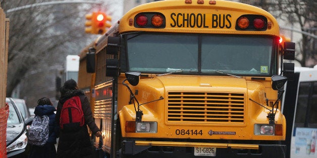 NEW YORK, NY - JANUARY 15: Students walk to board a school bus in Manhattan's East Village on January 15, 2013 in New York City. Drivers of the city's school buses are set to go on strike tomorrow after negotiations with Mayor Michael Bloomberg failed to reach an agreement; over 150,000 children will need to find an alternate method of transportation to school. (Photo by Mario Tama/Getty Images)