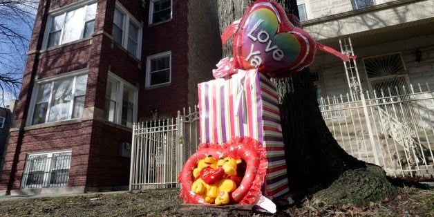 A makeshift memorial is seen in Chicago, Tuesday, March 12, 2013, at the site where 6-month-old girl Jonylah Watkins, and her father, a known gang member, were shot Monday, March 11. The girl, who was shot five times, died Tuesday morning. She became the latest homicide victim of a bloody gang war in Chicago when a man approached a van in which her father was changing her diaper and opened fire. Her father, Jonathan Watkins, was in serious but stable condition. (AP Photo/M. Spencer Green)