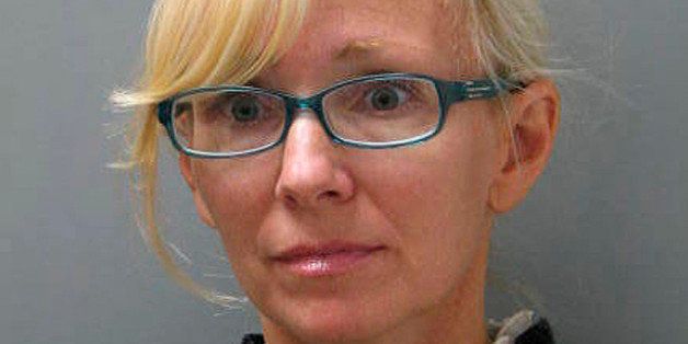 In this undated photo provided Wednesday, Nov. 5, 2014 by the Delaware State Police, Molly Shattuck, of Baltimore, poses for a police mug shot. Shattuck, 47, a former Baltimore Ravens cheerleader and the estranged wife of a prominent Maryland energy executive has been arrested and charged in connection with a sexual relationship involving a 15-year-old boy. Shattuck was indicted Monday, Nov. 3, 2014, on two counts of third-degree rape, four counts of unlawful sexual contact and three counts of providing alcohol to minors. (AP Photo/Delaware State Police)