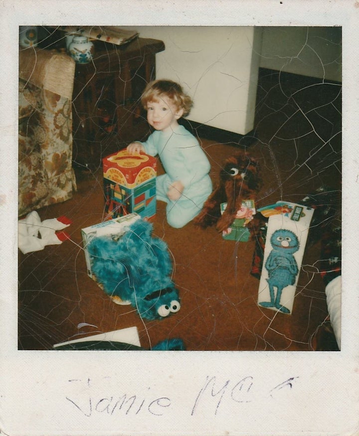 Jamie McGonnigal as a child at Christmas with his "Sesame Street" toys.