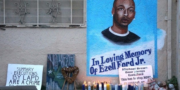 LOS ANGELES, CA - DECEMBER 05 : Candles burn at a memorial for Ezell Ford in Los Angeles as protestors demonstrate as people gather to protest after two grand juries decided not to indict the police officers involved in the deaths of Michael Brown in Ferguson, Mo. and Eric Garner in New York, N.Y. on December 05, 2014 in Los Angeles, United States. (Photo by Mintana Neslihan Eroglu/Anadolu Agency/Getty Images)