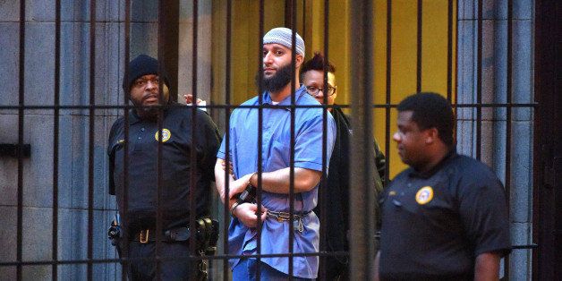 Officials escort 'Serial' podcast subject Adnan Syed from the courthouse following the completion of the first day of hearings for a retrial in Baltimore on Wednesday, Feb. 3, 2016. (Karl Merton Ferron/Baltimore Sun/TNS via Getty Images)