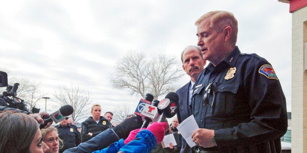 Albuquerque, N.M., Police Chief Gorden Eden, right, speaks to reporters as Albuquerque Mayor Richard Berry, left, listens to