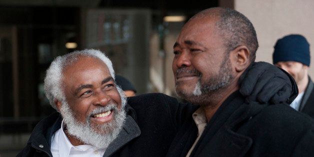 Wiley Bridgeman, 60, of Cleveland, left, is all smiles as his brother Ronnie, who is now known as Kwame Ajamu chokes up as they walk from the Cuyahoga County Justice Center after Bridgeman's release from a life sentence for a 1975 murder, Friday, Nov. 21, 2014 in Cleveland. The dismissal came after the key witness against Bridgeman, his brother and childhood friend Ricky Jackson recanted last year and said Cleveland police detectives coerced him into testifying that the three killed businessman Harry Franks the afternoon of May 19, 1975. (AP Photo/Phil Long)