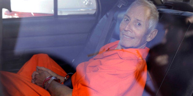 Robert Durst is transported from Orleans Parish Criminal District Court to the Orleans Parish Prison after his arraignment in New Orleans, Tuesday, March 17, 2015. Durst was rebooked on charges of being a convicted felon in possession of a firearm, and possession of a weapon with a controlled dangerous substance, a small amount of marijuana. (AP Photo/Gerald Herbert)