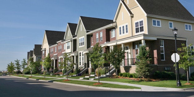 Perfectly manicured row of suburban townhouses on a beautiful summer day.