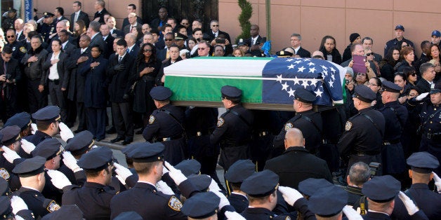 NEW YORK, NY - DECEMBER 27: Pallbearers carry the casket during the funeral of slain New York Police Department (NYPD) officer Rafael Ramos at the Christ Tabernacle Church on December 27, 2014 in the Glenwood section of the Queens borough of New York City. Ramos was shot, along with Police Officer Wenjian Liu while sitting in their patrol car in an ambush attack in Brooklyn on December 20. Thousands of fellow officers, family, friends and Vice President Joseph Biden arrived at the church for the funeral. (Photo by Kevin Hagen/Getty Images)