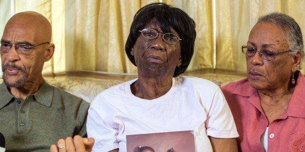 Earl Ofari Hutchinson, founder of the Los Angeles Urban Policy Roundtable, left, Ada Moses, 91, the grandmother of Alesia Thomas, who died in 2012 after allegedly being kicked by a Los Angeles Police Department officer while handcuffed, holding a photo of her grand daughter, seen at left with little sister, and Lita Herron, a community activist, take questions from the media in Los Angeles on Friday, Oct. 11, 2013. Attorneys are demanding the LAPD release a video that authorities say shows an officer kicking Thomas repeatedly while she was handcuffed. LAPD Officer Mary O'Callaghan was charged Thursday, Oct. 10, 2013, with felony assault under the color of authority for the 2012 confrontation with Thomas. (AP Photo/Damian Dovarganes)