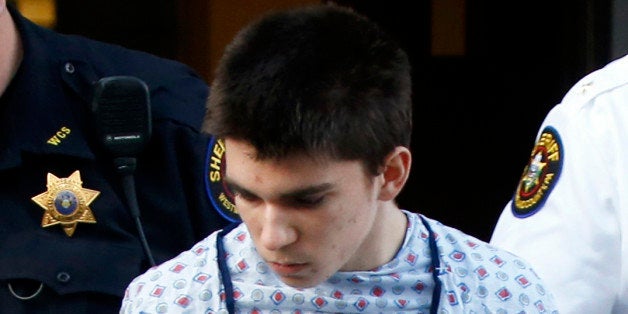 Alex Hribal, the suspect in the stabbings at the Franklin Regional High School near Pittsburgh, is taken from a district magistrate after he was arraigned on charges in the attack on Wednesday, April 9, 2014 in Export, Pa. Authorities say Hribal has been charged after allegedly stabbing and slashing at least 21 people, mostly students, in the crowded halls of his suburban Pittsburgh high school Wednesday. (AP Photo/Keith Srakocic)