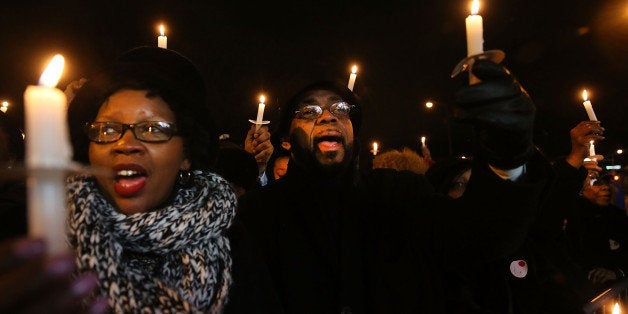 NEW YORK, NY - JANUARY 19: People participate in a candlelight vigil and wreath laying ceremony with the Reverend Al Sharpton at the location where Eric Garner was killed during a scuffle with police last year on January 19, 2015 in New York City. The gathering was one of the 'Be Like King' events held on Dr. Martin Luther King, Jr day to honor and promote King's work as a civil rights activist. Sharpton and other participants with the National Action Network (NAN) also held a wreath laying ceremony at the site where police officers Wenjian Liu and Rafael Ramos were killed in the Bedford-Stuyvesant neighborhood of Brooklyn. (Photo by Spencer Platt/Getty Images)