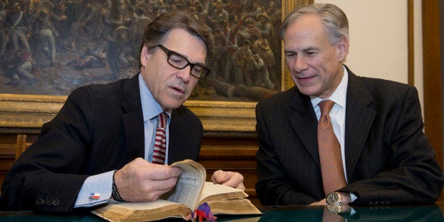 Texas Gov. Rick Perry, left, points out a passage in the Governor Neff Bible that he marked for Texas Gov.-elect Greg Abbott, right, prior to the swearing in ceremony at the Capitol, Monday, Jan 19, 2015. In a tradition that dates back to 1925, Perry marked Matthew 20:25-28 for Abbott who will take the oath of office on Tuesday. (AP Photo/Texas Tribune, Bob Daemmrich, Pool)