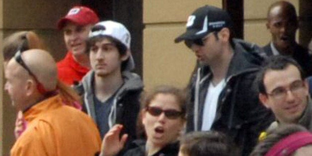 This Monday, April 15, 2013 photo provided by Bob Leonard shows bombing suspects Tamerlan Tsarnaev, 26, center right in black hat, and his brother, Dzhokhar A. Tsarnaev, 19, center left in white hat, approximately 10-20 minutes before the blasts that struck the Boston Marathon. (AP Photo/Bob Leonard)