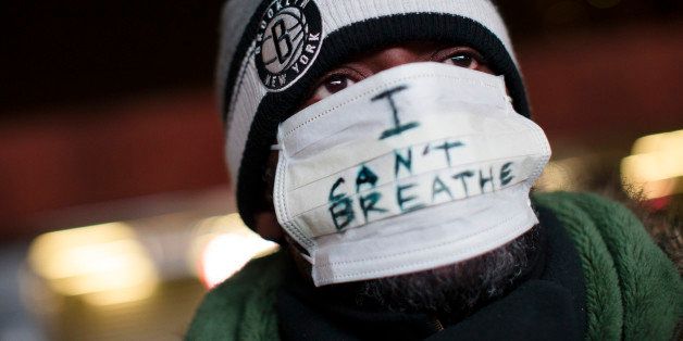 A protestor attends a rally outside the Barclays Center against a grand jury's decision not to indict the police officer involved in the death of Eric Garner, Monday, Dec. 8, 2014, in the Brooklyn borough of New York. Britain's Prince William, the Duke of Cambridge, and Kate, Duchess of Cambridge, not pictured, attended a NBA basketball game between the Cleveland Cavaliers and the Brooklyn Nets at Barclays Center. (AP Photo/John Minchillo)
