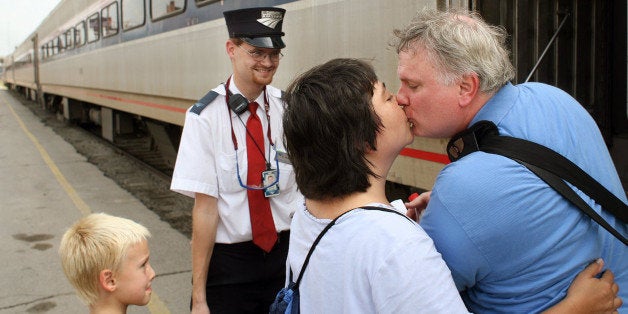Amtrak assistant conductor Brandon Bostian stands by on Aug. 21, 2007 as Sandra Palmer of University City says goodbye to her