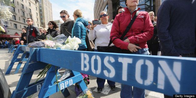 BOSTON, MA - APRIL 22: People gather during a moment of silence honoring the Boston Marathon bombing victims in Copley Square, near the bombing sites, on April 22, 2013 in Boston, Massachusetts. Massachusetts Gov. Deval Patrick asked residents to observe a moment of silence at the time of the first explosion at 2:50 p.m. this afternoon, the same day suspect Dzhokhar Tsarnae was charged with using a weapon of mass destruction. (Photo by Mario Tama/Getty Images)