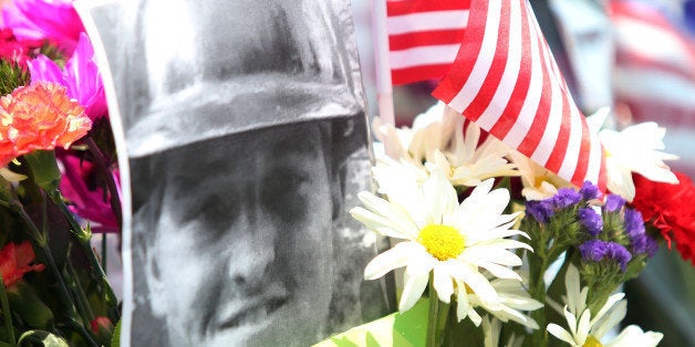 A fallen firefighter's picture is part of a memorial outside of the Granite Mountain Hotshot fire station in Prescott, Arizon