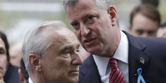 FILE - In this Sept. 11, 2014 file photo, New York City Police Commissioner Bill Bratton, left, and Mayor Bill de Blasio talk during memorial observances at the site of the World Trade Center in New York. De Blasioￃﾢￂﾀￂﾙs relationship with police, already strained by accusations he sided with frequent NYPD critic Al Sharpton over the chokehold death of an unarmed suspect, suffered another hit with revelations a top aide is living with a convicted killer who has often mocked officers as ￃﾢￂﾀￂﾜpigs.ￃﾢￂﾀￂﾝ(AP Photo/Mark Lennihan, Pool, File)