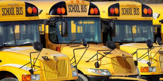 Public school buses are parked unused Wednesday, Jan. 7, 2015, in Springfield, Ill., as schools closed and warming shelters o