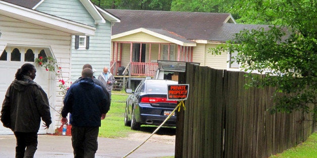 Investigators work at a scene of a shooting in Hollywood, S.C., Thursday, May 7, 2015. A sheriff's deputy responding to a hom