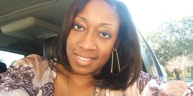 This undated family photo provided by Lincoln B. Alexander shows, Marissa Alexander in her car in Tampa, Fla. Alexander had never been arrested before she fired a bullet at a wall one day in 2010 to scare off her husband when she felt he was threatening her. Nobody got hurt, but this month a northeast Florida judge was bound by state law to sentence her to 20 years in prison. (AP Photo/Lincoln B. Alexander)