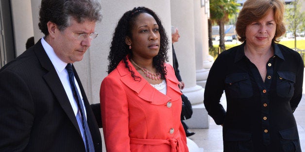 FILE - In a Tuesday, June 10, 2014 file photo, Marissa Alexander is flanked by defense co-counsel Bruce Zimet, left, and Faith Gay, right, stand with as they speak to the media, in Jacksonville, Fla. Alexander, who claimed self-defense after prosecutors say she fired a gun at her estranged husband and his two sons, is expected to be released from prison Tuesday, Jan. 27, 2015, after accepting a plea agreement for time served. (AP Photo/The Florida Times-Union, Bob Mack, Pool)