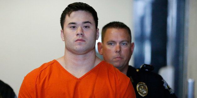 Daniel Holtzclaw, front, an Oklahoma City police officer accused of sexually assaulting women he encountered while on patrol in neighborhoods near the state Capitol, is led into a courtroom for a hearing on whether to cut his bond from $5 million to $139,000, in Oklahoma City, Wednesday, Sept. 3, 2014. (AP Photo/Sue Ogrocki)
