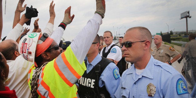 FERGUSON, MO - SEPTEMBER 10: Police block demonstrators from gaining access to Interstate Highway 70 on September 10, 2014 near Ferguson, Missouri. The demonstrators had planned to shut down I70 but their efforts were thwarted by a large contingent of police from several area departments. Ferguson, in suburban St. Louis, is recovering from nearly two weeks of violent protests that erupted after teenager Michael Brown was shot and killed by Ferguson police officer Darren Wilson last month. (Photo by Scott Olson/Getty Images)