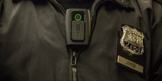 NEW YORK, NY - DECEMBER 03: New York Police Department (NYPD) Officer Joshua Jones demonstrates how to use and operate a body camera during a press conference on December 3, 2014 in New York City. The NYPD is beginning a trial exploring the use of body cameras; starting Friday NYPD officers in three different precincts will begin wearing body cameras during their patrols. (Photo by Andrew Burton/Getty Images)