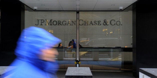 A pedestrian passes by JPMorgan Chase & Co. offices in New York, U.S., on Tuesday, Jan. 7, 2014. JPMorgan Chase & Co. agreed