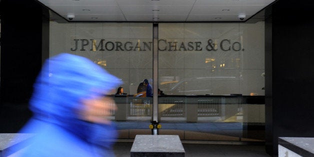 A pedestrian passes by JPMorgan Chase & Co. offices in New York, U.S., on Tuesday, Jan. 7, 2014. JPMorgan Chase & Co. agreed to pay $1.7 billion to settle U.S. claims that it facilitated Bernard Madoffs Ponzi scheme, the largest in U.S. history, resolving yet another legal obstacle facing the embattled bank. Photographer: Peter Foley/Bloomberg via Getty Images