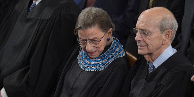 US Supreme Court Justices Ruth Bader Ginsburg (L), and Stephen Breyer (R) listen as US President Barack Obama delivers the State of the Union address before a joint session of Congress on January 28, 2014 at the US Capitol in Washington. AFP PHOTO/Brendan SMIALOWSKI (Photo credit should read BRENDAN SMIALOWSKI/AFP/Getty Images)