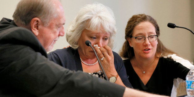 Debra Milke cries as she is attended to by by Attorneys Lori Voepel, right, and Michael Kimerer during a news conference, Tuesday, March 24, 2015, in Phoenix. Milke spoke out for the first time after spending two decades on death row in the killing of her son. Her case was dismissed earlier this week. (AP Photo/Matt York)