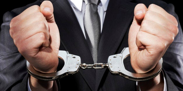 Businessman hand cuffed (mid section)